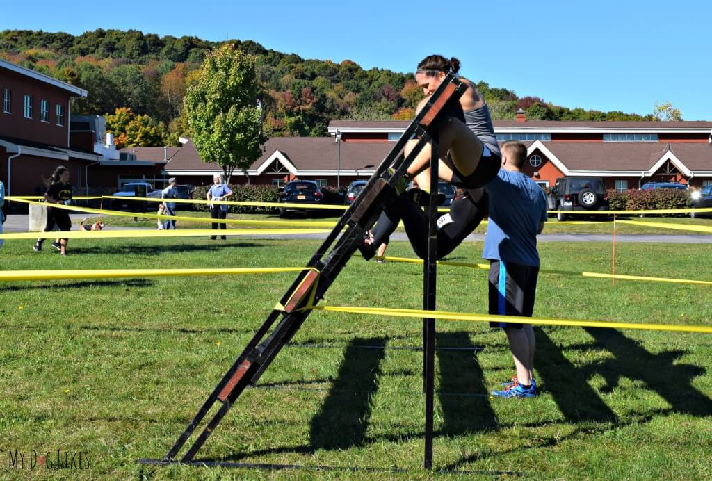 Rachael climbing an inverted obstacle at Lollypop Farm's Ruff Rampage 5K