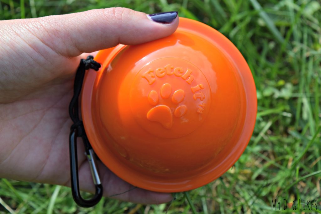 Showing off a closed Fetch It Case - with a tennis ball inside