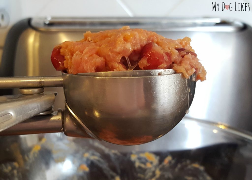 Use an ice cream scoop to portion out the pupcakes into a baking pan.