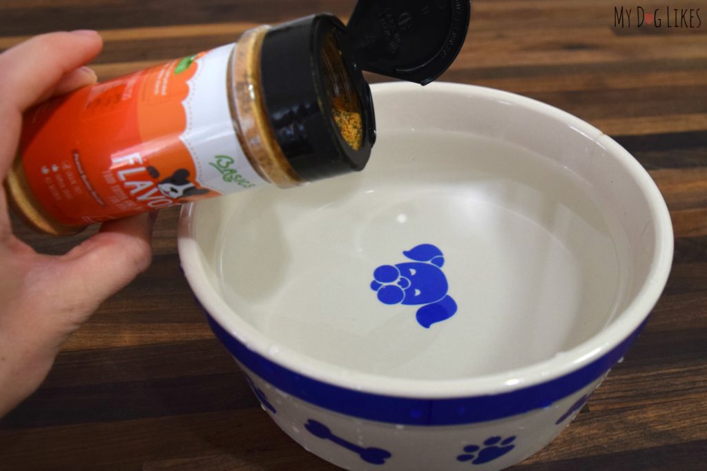 Adding some flavor to our dogs bowl to encourage them to drink more water.